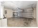 Spacious garage with door to backyard and interior access with storage shelving at 6561 Sw 129Th Loop, Ocala, FL 34473