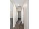 Hallway featuring wood-look flooring, fresh paint, and convenient access to multiple rooms at 6561 Sw 129Th Loop, Ocala, FL 34473