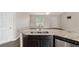 View of the kitchen island with double sinks, stainless steel dishwasher, and an open floor plan at 6561 Sw 129Th Loop, Ocala, FL 34473