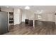 Open kitchen and living area showcasing a kitchen island and wood-look flooring at 6561 Sw 129Th Loop, Ocala, FL 34473