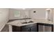 Kitchen island with double sinks, stainless steel dishwasher, and an open floor plan at 6561 Sw 129Th Loop, Ocala, FL 34473