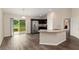 Open concept kitchen with stainless steel appliances and an island with a stone counter at 6561 Sw 129Th Loop, Ocala, FL 34473