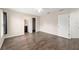 Bright main bedroom featuring wood-look floors and access to an ensuite bathroom and closet at 6561 Sw 129Th Loop, Ocala, FL 34473
