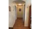 Hallway features wooden flooring, neutral walls, and access to multiple rooms, providing a seamless transition at 7251 Sw 115Th Pl, Ocala, FL 34476