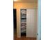 Well-organized hallway closet with shelves, providing ample storage space for linens and household items at 7251 Sw 115Th Pl, Ocala, FL 34476