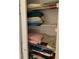 Shelves filled with neatly folded towels and linens providing ample storage in this convenient linen closet at 7251 Sw 115Th Pl, Ocala, FL 34476