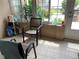 Relaxing patio area featuring comfortable seating, tile flooring, and natural light streaming through the windows at 7251 Sw 115Th Pl, Ocala, FL 34476