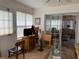Bright sunroom featuring a television and easy access to the outdoors through a sliding glass door at 7251 Sw 115Th Pl, Ocala, FL 34476