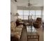 Bright sunroom with a ceiling fan and comfortable seating around a glass table, perfect for relaxation and enjoying the sunlight at 7251 Sw 115Th Pl, Ocala, FL 34476