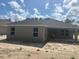 Rear view of single-story home with a covered patio and spacious backyard area at 7637 Sw 180Th Cir, Dunnellon, FL 34432