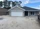 Charming single-story home with a two-car garage and well-manicured lawn at 7637 Sw 180Th Cir, Dunnellon, FL 34432