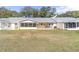 The backyard features a lawn, screened-in patio, and an open patio with a hot tub, perfect for outdoor relaxation at 8420 Sw 93 Ln # E, Ocala, FL 34476