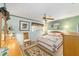 Cozy bedroom with a ceiling fan and a quilt-covered bed and decorative floral area rug at 8420 Sw 93 Ln # E, Ocala, FL 34476