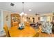 Open dining room showcasing a wooden table, chandelier, and connection to the living area at 8420 Sw 93 Ln # E, Ocala, FL 34476
