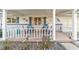 Inviting front porch featuring comfortable seating and decorative accents for relaxation at 8420 Sw 93 Ln # E, Ocala, FL 34476