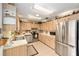 Well-lit kitchen with stainless steel appliances and ample cabinet space at 8420 Sw 93 Ln # E, Ocala, FL 34476