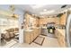 Well-lit kitchen with light-colored cabinets, stainless steel appliances, and a view to an adjoining sunroom at 8420 Sw 93 Ln # E, Ocala, FL 34476