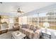 Bright sunroom with comfortable seating and large windows overlooking the backyard at 8420 Sw 93 Ln # E, Ocala, FL 34476