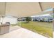 Covered patio area with a view of the well-maintained backyard and surrounding homes at 8420 Sw 93 Ln # E, Ocala, FL 34476