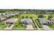Beautiful home showing lush landscaping, surrounded by a golf course, and other homes in the neighborhood at 8772 Se 130Th Loop, Summerfield, FL 34491