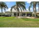 Exterior view of backyard patio with furniture, lush landscaping, and a well-maintained lawn at 8772 Se 130Th Loop, Summerfield, FL 34491