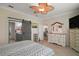 Bedroom with dresser, tv, slider barn door, and doorway views into bathroom and living area at 8772 Se 130Th Loop, Summerfield, FL 34491