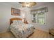 Bedroom features a ceiling fan, natural light, and decoratively themed furnishings at 8772 Se 130Th Loop, Summerfield, FL 34491