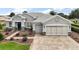 Charming single-Gathering home with well-manicured landscaping and a three-car garage at 8772 Se 130Th Loop, Summerfield, FL 34491