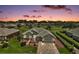 Beautiful single-Gathering home showcasing lush landscaping, stone driveway, and exterior paint during a lovely sunset at 8772 Se 130Th Loop, Summerfield, FL 34491