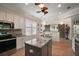 Kitchen features white cabinets, granite countertops, stainless appliances, pendant lighting, and a breakfast nook at 8772 Se 130Th Loop, Summerfield, FL 34491