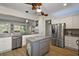 Spacious kitchen boasts stainless steel appliances, custom island, and seamless open layout to living spaces at 8772 Se 130Th Loop, Summerfield, FL 34491