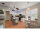 Bright eat-in kitchen with stainless steel appliances, center island, granite counters, and charming breakfast table at 8772 Se 130Th Loop, Summerfield, FL 34491
