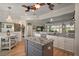 Kitchen view with granite counters, center island, stainless appliances, and an open design to the living area at 8772 Se 130Th Loop, Summerfield, FL 34491