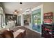 Enclosed lanai features brick floors, ceiling fans, mini-split AC, and views of living room and backyard through sliding glass doors at 8772 Se 130Th Loop, Summerfield, FL 34491