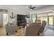 Comfortable living room with a large TV, a cozy fireplace, and sliding glass doors to the patio at 8772 Se 130Th Loop, Summerfield, FL 34491
