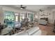Bright and airy living room featuring comfortable seating, large windows, and stylish decor at 8772 Se 130Th Loop, Summerfield, FL 34491