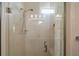 Modern shower with glass door, shower head, bench, and white marble tile at 8772 Se 130Th Loop, Summerfield, FL 34491