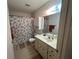 Bathroom featuring a single sink vanity, toilet, and shower with a seashell themed shower curtain at 8801 Sw 92Nd St # B, Ocala, FL 34481