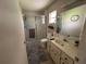 Bathroom featuring a single sink vanity, toilet, and shower with sliding glass doors at 8801 Sw 92Nd St # B, Ocala, FL 34481