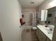 Bathroom featuring a single sink vanity, toilet, and shower with a seashell themed shower curtain at 8801 Sw 92Nd St # B, Ocala, FL 34481