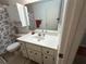 Bathroom featuring a single sink vanity, toilet, and shower with a seashell themed shower curtain at 8801 Sw 92Nd St # B, Ocala, FL 34481