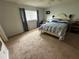 Comfortable bedroom with a ceiling fan and a large window at 8801 Sw 92Nd St # B, Ocala, FL 34481