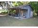 Quaint metal barn with a concrete pad and open-air workstation, perfect for projects at 1050 E Highway 329, Citra, FL 32113