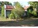 Exterior of the house needing improvements surrounded by mature trees and grass at 1050 E Highway 329, Citra, FL 32113