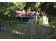 Quaint cottage-style home with mature trees and landscaping, needs renovation at 1050 E Highway 329, Citra, FL 32113