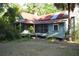 Single-story home with a screened front porch and mature palm trees at 1050 E Highway 329, Citra, FL 32113