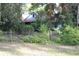 Charming home needing TLC with mature trees and overgrown landscaping at 1050 E Highway 329, Citra, FL 32113