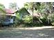 Exterior of the residence showcases the rustic charm and yard needing some TLC at 1050 E Highway 329, Citra, FL 32113