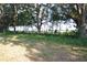Picturesque land with mature trees in the background, enhancing privacy and natural beauty at 1050 E Highway 329, Citra, FL 32113