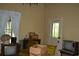 Photo shows interior living room with curtains, box and contents, and outdated televisions at 1050 E Highway 329, Citra, FL 32113